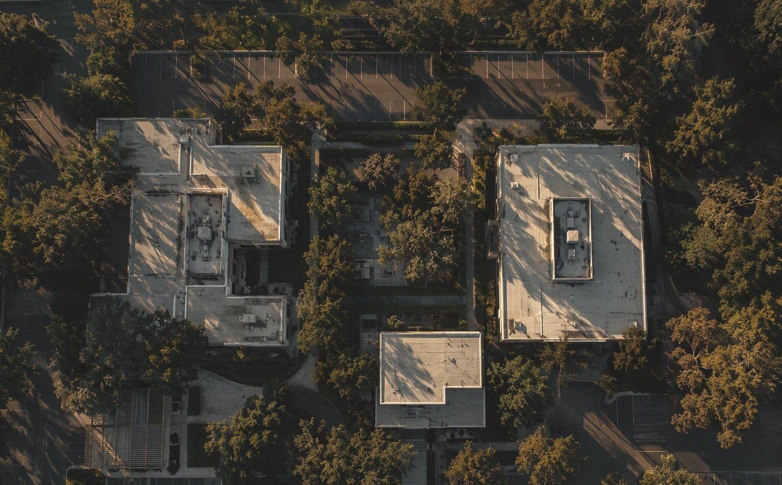 Aerial view of an office campus among oak trees